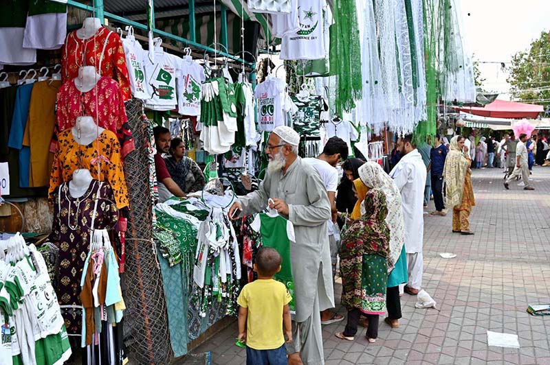 Citizens purchase green and white Independence Day merchandise including T-shirts, flags and accessories from stalls at H-9 weekly bazaar, as the nation gears up to celebrate Pakistan's 79th Independence Day on August 14
