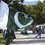 National flags are displayed by a seasonal vendor along a roadside at Melody to attract customers ahead of Pakistan’s 79th Independence Day celebrations on August 14