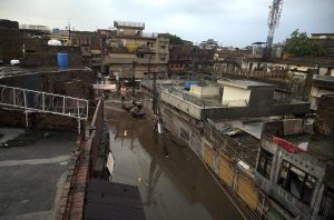 Residents wade through knee-deep floodwater as heavy rains submerge streets near imam bara chowk.