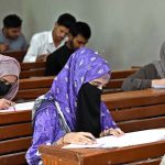 Candidates solving question paper during entry test for The University of Larkana