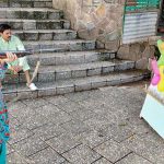 A young girl takes careful aim at a colourful array of balloons during a shooting game at Shakarpatrian area in the Federal Capital