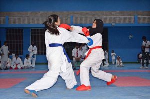 Young female karate players compete during the 1st Junior South Punjab Azadi Karate Championship at the Sports Gymnasium.