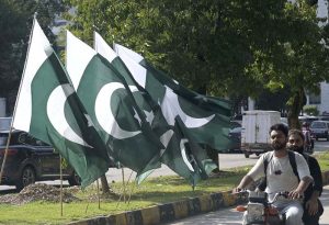 National flags are displayed by a seasonal vendor along a roadside at Melody to attract customers ahead of Pakistan’s 79th Independence Day celebrations on August 14