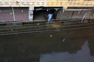 Residents wade through knee-deep floodwater as heavy rains submerge streets near imam bara chowk.