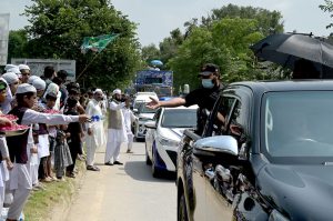Madrasa children serve water bottle of the participants of a rally celebrating the 12th Rabi-ul-Awal (the birth anniversary of Prophet Muhammad ﷺ)