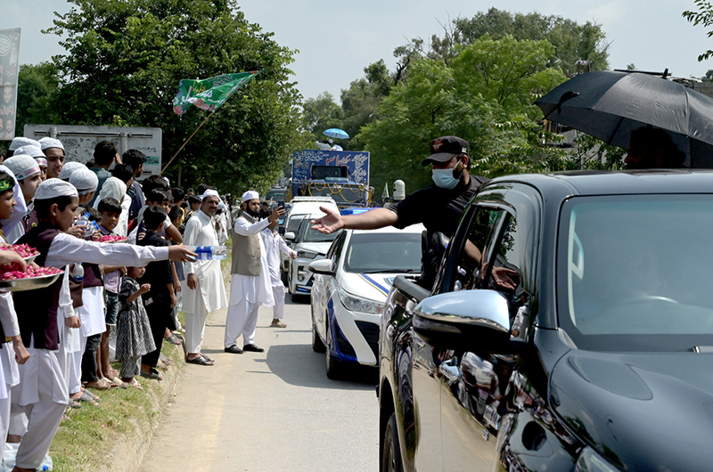 Madrasa children serve water bottle of the participants of a rally celebrating the 12th Rabi-ul-Awal (the birth anniversary of Prophet Muhammad ﷺ)