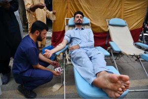 Volunteers donate blood at a blood donation camp organized by the Regional Blood Center Hayatabad at Qissa Khawani Bazaar.