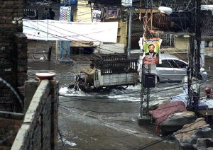 Residents wade through knee-deep floodwater as heavy rains submerge streets near imam bara chowk.