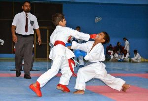 Young female karate players compete during the 1st Junior South Punjab Azadi Karate Championship at the Sports Gymnasium.