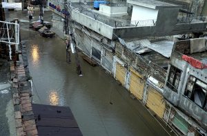 Residents wade through knee-deep floodwater as heavy rains submerge streets near imam bara chowk.
