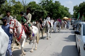 Madrasa children serve water bottle of the participants of a rally celebrating the 12th Rabi-ul-Awal (the birth anniversary of Prophet Muhammad ﷺ)