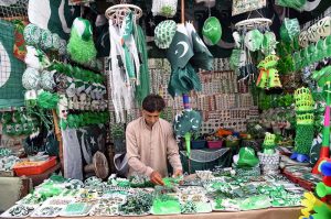 A vendor displays national flags and other Independence Day items to attract customers ahead of Pakistan’s 79th Independence Day celebrations on August 14.