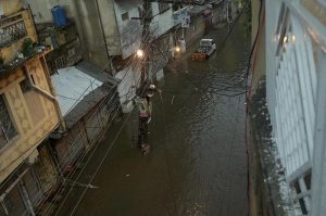 Residents wade through knee-deep floodwater as heavy rains submerge streets near imam bara chowk.