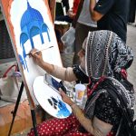 A student busy making a painting at stall near Peshawar Morr in the Federal Capital