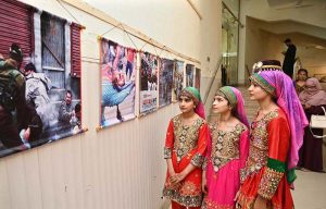 Students are presenting a patriotic tableau at the Sargodha Arts Council during an event marking 'Youm-e-Istehsal-e-Kashmir' (Day of Exploitation of Kashmir); the performance depicts the struggle of the Kashmiri people, as well as the brutality and human rights violations committed by Indian forces.