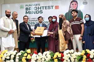 Commissioner Sargodha Hafiz Shaukat Ali and Chairman Board of Intermediate and Secondary Education (BISE) Sargodha Abbas Haider Gondal present an award to the first position holder in the Matriculation Examination 2026 during a prize distribution ceremony at the BISE Multipurpose Hall.