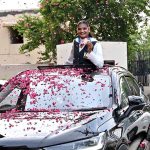 National boxer Fatima Zara proudly displays her Commonwealth Games bronze medal upon arrival at the Sports Gymnasium, where the District Sports Department hosted a reception in her honour and welcomed her with flower petals