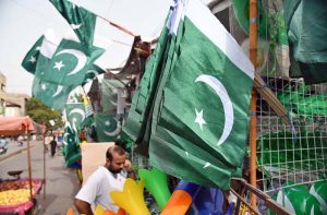 A vendor displays national flags and other Independence Day items to attract customers ahead of Pakistan’s 79th Independence Day celebrations on August 14.