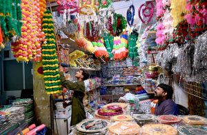 Shopkeepers are selling decorative items in connection with the celebration of Eid Milad-un-Nabi on Gumpat Road.