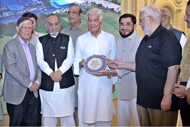 Chairman Sialkot Medical City Khawaja Masood Akhtar presenting a sheild to Defense Minister Khawaja Muhammad Asif