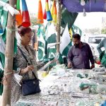 People purchase national flags, badges, pennants and other patriotic items as the nation prepares to celebrate Independence Day with traditional zeal and enthusiasm