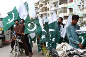 People purchase national flags, badges, pennants and other patriotic items as the nation prepares to celebrate Independence Day with traditional zeal and enthusiasm
