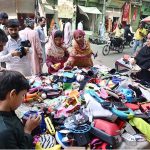 Customers select and purchase used toys and household items at Landa Bazaar