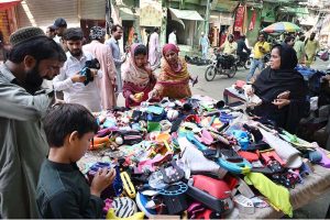 Customers select and purchase used toys and household items at Landa Bazaar