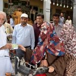 Federal Minister for board of investment, Qaiser Ahmad Shaikh distributing 5 litre free petrol slips to the motor cycles and rickshaw in the celebration of Independence Day