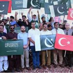 Civil society representatives and citizens raise the flags of Pakistan, Saudi Arabia and Türkiye during a ceremony organized by the district administration at Gulshan-e-Iqbal Park to celebrate the Mecca Defence Agreement among the three countries