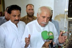 Federal Minister for board of investment, Qaiser Ahmad Shaikh distributing 5 litre free petrol slips to the motor cycles and rickshaw in the celebration of Independence Day