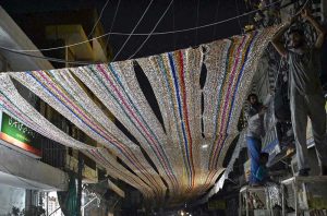 People decorate Khuda Bakhsh Road with colourful ribbons, glittering decorative sheets and other embellishments in connection with the upcoming Eid Milad-un-Nabi (PBUH) celebrations.