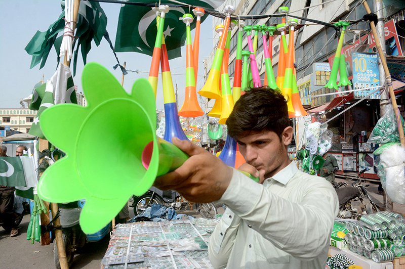 A vendor display and sells pressure horns along the roadside at Saddar market despite a ban imposed by the authorities during the Independence Day celebrations