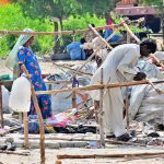 A gypsy family busy in preparing temporary hut for living outside road at Makki Shah Area