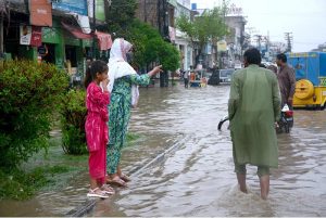 A road remains flooded with accumulated rainwater after heavy rainfall, causing inconvenience to motorists and pedestrians in the city.