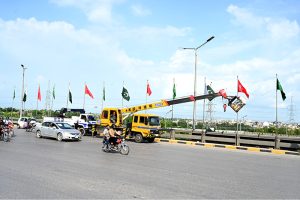 Workers hoist flags ahead of celebrations marking the Makkah Joint Defence Agreement, signed by Pakistan, Saudi Arabia, and Türkiye on August 7, 2026, at Al-Safa Palace in Makkah
