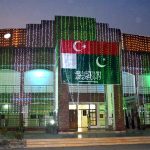 A view of the beautifully illuminated Sargodha Arts councial building with green lights and national flags on the eve of celebrations marking the Makkah Joint Defence Agreement signed by Pakistan, Saudi Arabia and Türkiye