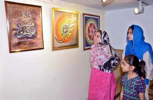 Visitors view a calligraphy exhibition organized in connection with the Jashn-e-Eid Milad-un-Nabi (PBUH) celebrations at the Arts Council.