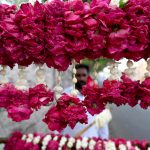 A vendor displaying the flowers garlands to attract the customers on the roadside footpath in the Provincial Capital