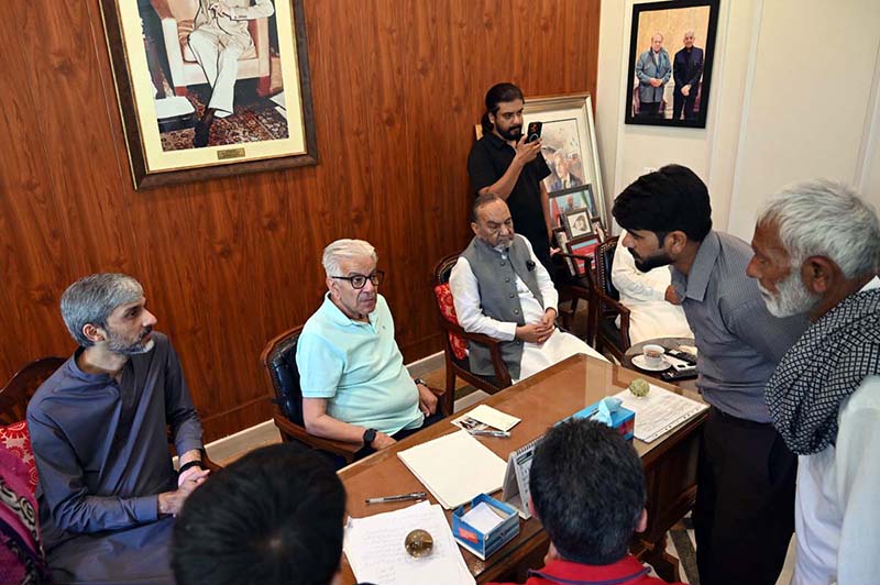 Defence Minister Khawaja Muhammad Asif listens to public grievances during a meeting with residents at his residence in Cantt