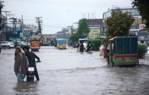 A road remains flooded with accumulated rainwater after heavy rainfall, causing inconvenience to motorists and pedestrians in the city.