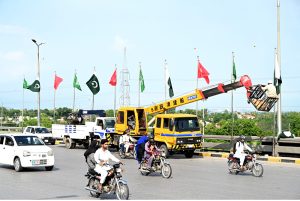 Workers hoist flags ahead of celebrations marking the Makkah Joint Defence Agreement, signed by Pakistan, Saudi Arabia, and Türkiye on August 7, 2026, at Al-Safa Palace in Makkah