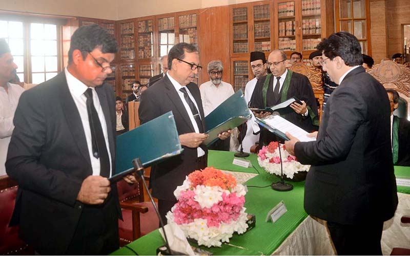 Chief Justice of the Sindh High Court Mr. Justice Zafar Ahmed Rajput administers the oath to three newly appointed Additional Judges during a ceremony at the Sindh High Court Committee Room