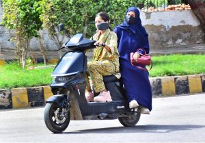 A girl rides an electric bike along Alamgir Road during routine traffic movement in the city