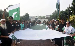 A family celebrates Independence Day on Mall Road in the city, expressing their patriotic spirit