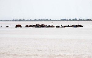 A panoramic view of a traditional fishermen's stilt village built over the Indus River near Aqil village reflects the unique lifestyle and rich cultural heritage of the local fishing community.