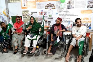 Persons with disabilities perform national songs during the Independence Day commemoration of Pakistan organized by the DIA Welfare Association