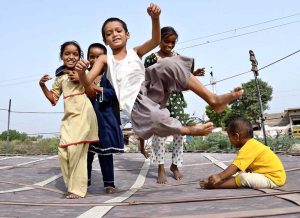 Children enjoy bouncing on a trampoline near the Railway Station