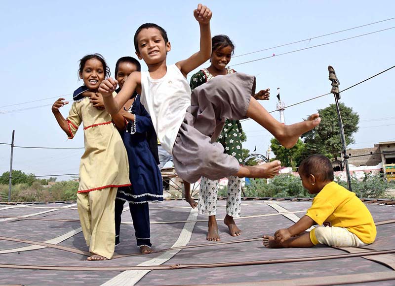 Children enjoy bouncing on a trampoline near the Railway Station