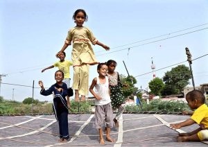 Children enjoy bouncing on a trampoline near the Railway Station